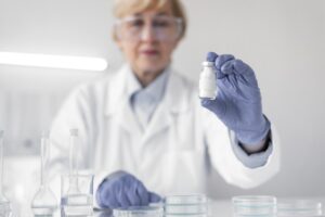 Scientist preparing glass vials for peptide reconstitution research in a modern laboratory.