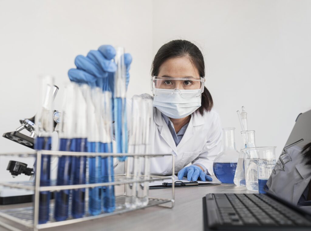 Scientist in a lab researching multi-agonist peptide formulations for GLP-1 therapies.