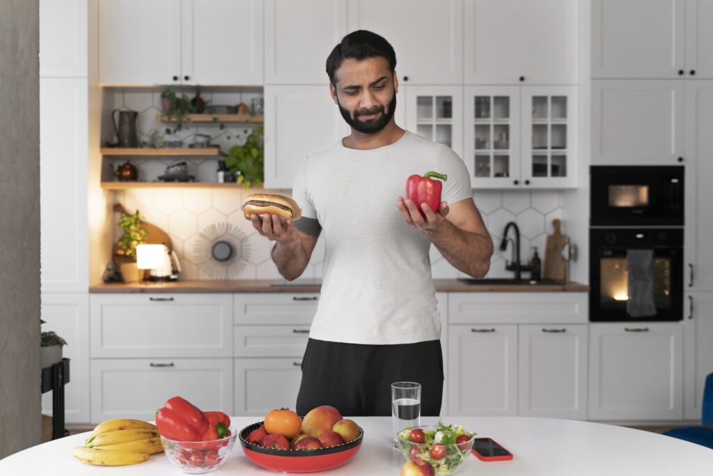 A man making a dietary choice between healthy eating and ultra-processed food in a GLP-1 metabolic health plan.