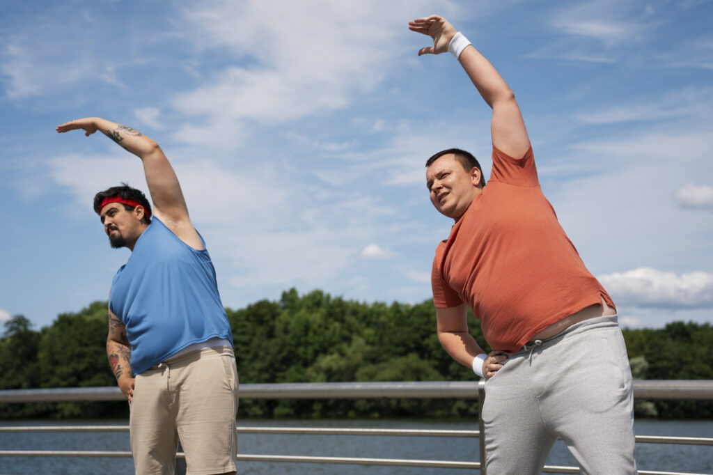 Two men performing resistance exercises to prevent sarcopenia and muscle loss on GLP-1 weight loss medications.