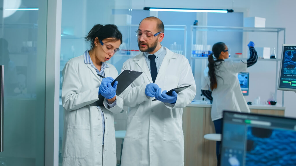Two researchers reviewing federal regulatory documents, representing the rulemaking record behind the July 2026 FDA advisory committee vote on peptide bulk drug substances.