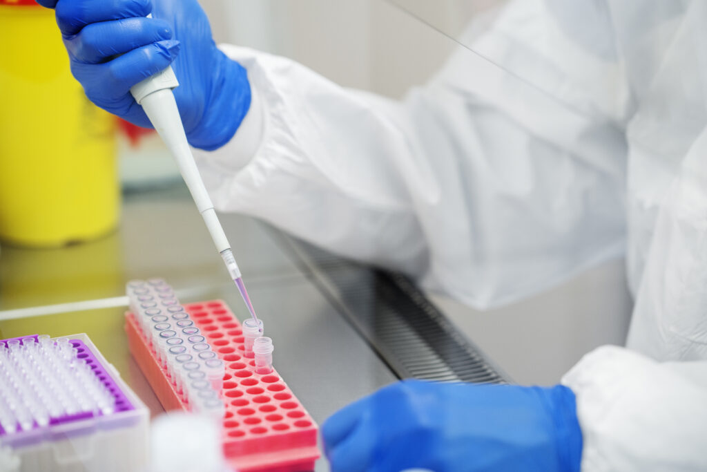 Researcher preparing cell cultures in a laboratory, representing the intact-cell preparations used in mitochondrial peptide assay design.