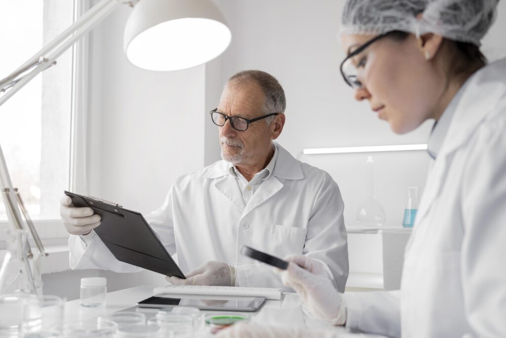 Researchers reviewing chromatographic purity data and peptide certificate of analysis documentation during reagent qualification in a preclinical laboratory.